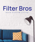 Living room with blue couch and orange pillow, floor lamp, Filter Bros logo on brick wall background. Replacement 400S Smokestop HEPA Filter for Blueair 480i and 400S Series Air Purifiers, Easy Fit for Models 402 403 405 410 450E 455EB 402PF, Keeps Your Air Fresh and Clean.
