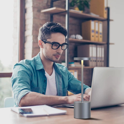 Man working with 2 Pack Cordless Desk Lamps With 5000mAh Rechargeable Battery on desk in home office, iron grey color.