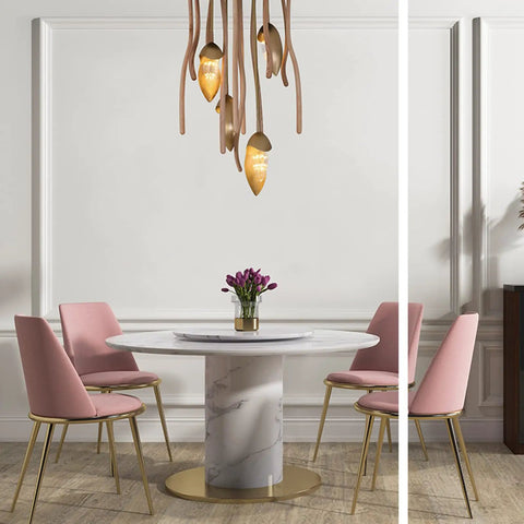 Sleek Three Light Solid Wood Pendant Lamp With Energy Saving Led Fixtures above a modern dining table with pink chairs.