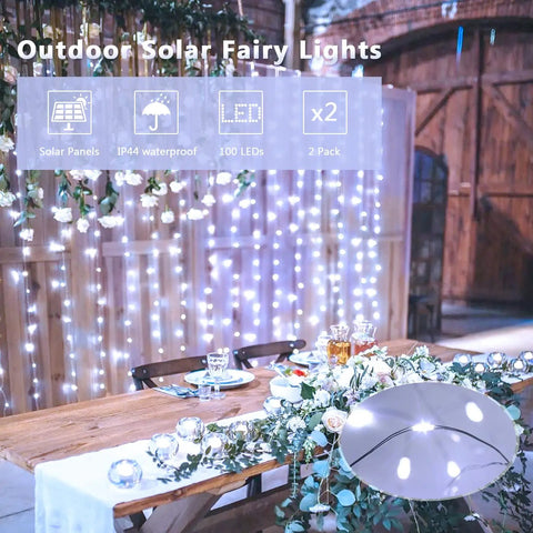 Garden wedding setup with Two Pack Of 33 Feet Solar String Lights With 100 LEDs Each, illuminating a rustic table.