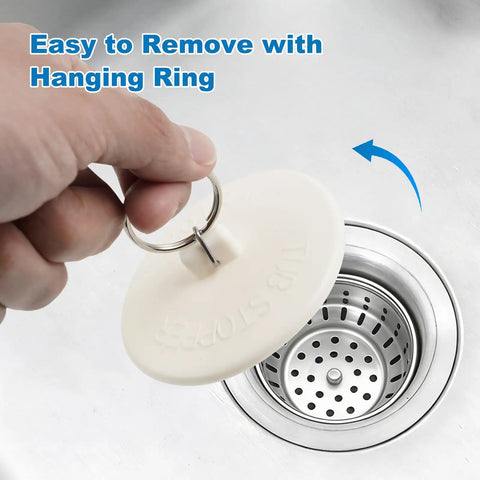Hand holding pull-ring of white rubber sink plug from Six Size Universal Drain Stopper Set With Pull Ring Rubber Sink Plugs For Kitchen Bath Laundry And Tub That Easily Fits Seven Eighths Inch To Two Inches Across Six Sizes White