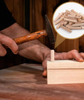 Person installing 90 Piece Hardwood Dowel Set in three sizes, one quarter inch, five sixteenths inch, and three eighths inch fluted grooved dowels.