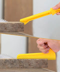 Close-up of hands using yellow safety push sticks from Five Pack Safety Push Blocks And Push Sticks Set on a table saw.
