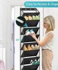 Woman adjusting black over-the-door shoe organizer with deep pockets holding 20 pairs, hanging on a closet door, tall 71 inch hanger.