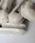 Close-up of glazed ceramic antenna insulators in a 22 pack, showing small ceramic isolators for dipole and other antenna setups.
