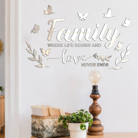 Dope 3D Acrylic Mirror Family Wall Decals Silver Finish With Motivational Quote Family Where Life Begins And Love Never Ends Plus Butterfly And Leaf Stickers DIY Removable Wall Art For Home Decor on a white wall above decor items