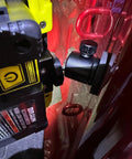 Magnetic camera mount with rubber-coated neodymium magnet and mini ball head securely attached to a red metal surface.