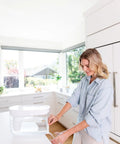 Woman using 18 Cup Home Water Filter Dispenser that really cleans water removing bacteria and parasites reducing microplastics and chemicals