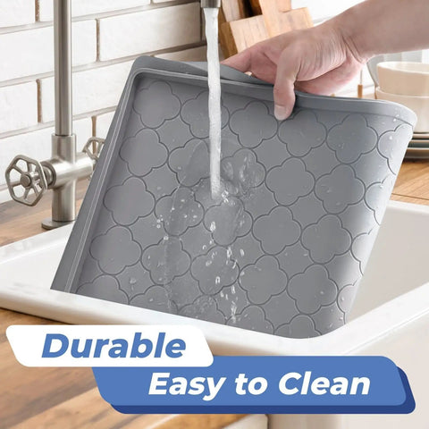 Person washing an Under Sink Waterproof Silicone Cabinet Mat 34 Inch by 22 Inch, Thick Edge Protector for Kitchen and Bathroom in a sink.