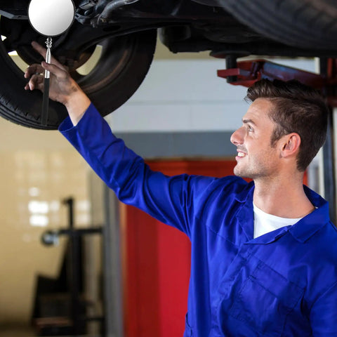 Mechanic using Telescoping Circular Inspection Mirror With Flexible Shaft 360 Degree Rotation Round Mirror Extended Handle 4 Inch Diameter on vehicle undercarriage in garage