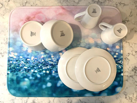 Premium Heavy Duty Polyester Kitchen Sink Dish Drying Mat With Ultra Absorbent Quick Dry Pads For Countertops And Delicate Glassware with plates and mugs.