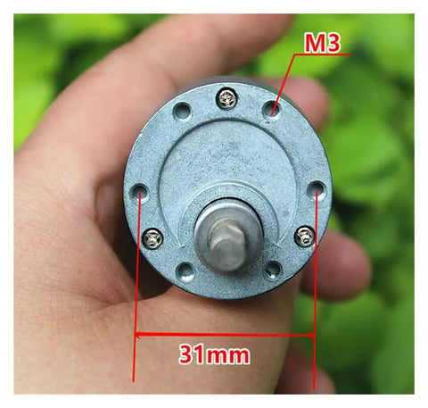 Hand holding a 37MM Geared Electronic Starter, showcasing solid metal gearbox, M3 holes, and 31mm diameter. Kickstart Your Build With This Heavy Duty 37 MM Geared Electronic Starter Boasting A Solid Full Metal Gearbox That Delivers Reliable 1000RPM Power On 6V Or 12V DC For Robot Cars.