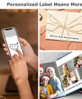 Person creating a custom label on smartphone with a heart design for personalizing gifts using the Slick Wireless Bluetooth Label Maker Machine With Three Self Adhesive Tapes And Portable Green Thermal Printer Kit For Quick Home Office School Organization And Cable Tagging Supplies.