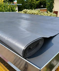 Ridiculously Durable Peel And Stick Waterproof Roofing Roll 39 X 32 Foot Self Adhesive Polyethylene on a roof surface.