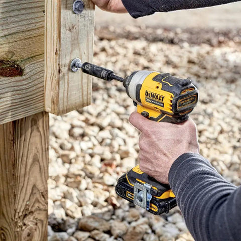 Person using Atomic 20V Max Impact Driver Kit with 1700 In-Lbs Torque, ultra-compact 5.1-inch body, cordless power in tight space