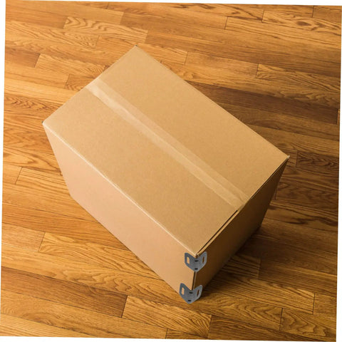 One Hundred Piece Heavy Duty Plastic Corner Protectors L Shaped Edge Guards protecting a cardboard box on a wooden floor.