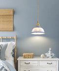 Ceramic Blue and White Pendant Light,Porcelain Light Fixture Kitchen Island hanging above a bedside table in a cozy bedroom.