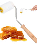 Pro Grade Honey Uncapping Roller Tool for Beekeepers, featuring sharp plastic prongs and wooden handle, with honeycomb