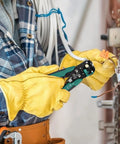 Heavy Duty Automatic Wire Stripper And Adjustable Crimping Tool being used with gloves for precise electrical wiring.