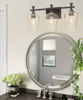 3 Light Bathroom Vanity Light Fixture With Metal Modern Frame above mirror, clear glass shades, oil-rubbed bronze finish