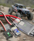 Beefy 60A Brushless ESC With WiFi Link for One Tenth RC Crawlers, shown with Axial SCX10 rock crawler car in a rocky terrain.