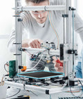Two people assembling a 3D printer with Ender 3 Glass Bed Upgrade Tempered Glass Plate Build Surface 235x235x4mm installed