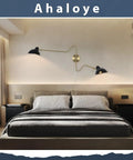 Modern bedroom with Plug In Black Wall Sconce With Swing Arm And 360 Degree Rotatable Shade On Off Cord Switch above bed.