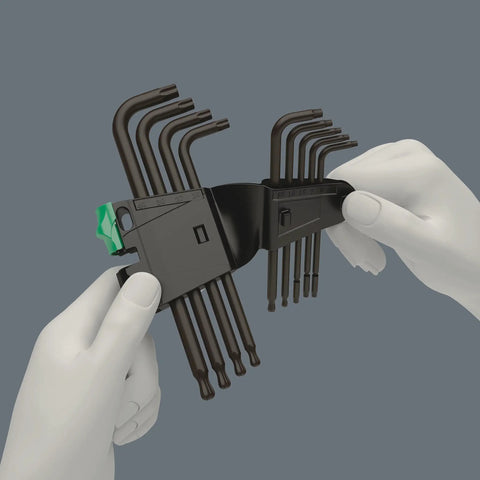 Hands holding TX L Key Set 9 Pc With Ballpoint Torx Long Arm BlackLaser Hardened Blades Hex Plus in clamshell packaging.