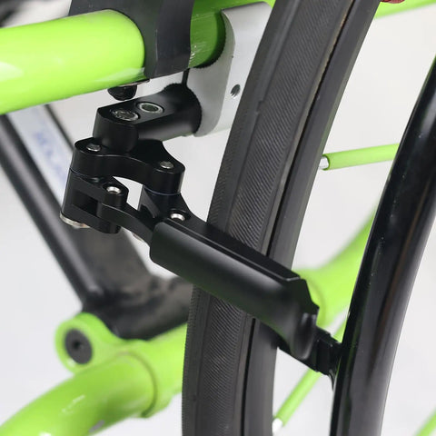 Close-up of Dual Composite Scissor Wheel Lock Set For Wheelchairs attached on green sports wheelchair frame.