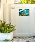Vintage Hawaiian Big Wave Tin Sign With Outrigger Canoe, Palm Trees And Hibiscus In Turquoise And Gold Tones on gate