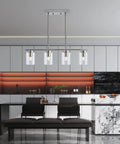 Four Light Brushed Nickel Island Pendant Lights With Clear Glass Shades for Kitchen Island above modern black table