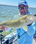 Angler holding a walleye using Rock Runner Slip Bouncer Weight With Quick Change Precision Sinker For Walleye Trolling In Super Glo Wonderbread.