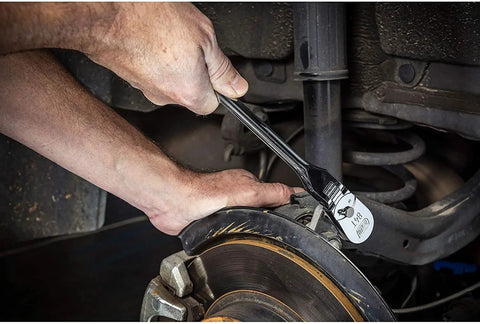 Person using 4 Piece Flex Handle Ratchet Set With 84 Tooth Ratchets on car brake system in tight spot