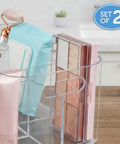 Five compartment makeup storage organizer set of two clear BPA free plastic caddy on a vanity with beauty products.