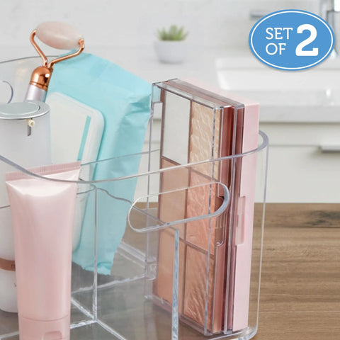 Five compartment makeup storage organizer set of two clear BPA free plastic caddy on a vanity with beauty products.