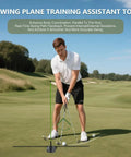 Man using Golf Alignment Stick Holder And Training Aid for aiming and swing plane practice on a green field