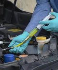 LEAKFINDER LF021 auto refrigerant leak detector kit; blue-gloved technician injects yellow dye into car AC hose