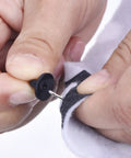 Installing a rubber pin from the DIY Craft Pin Back Set 50 Pair Rubber Butterfly Clutch Pin Backs Tie Tacks Blank Pins Holders For Craft Making And Jewelry Projects With Easy Grip Design on fabric.