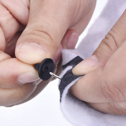 Installing a rubber pin from the DIY Craft Pin Back Set 50 Pair Rubber Butterfly Clutch Pin Backs Tie Tacks Blank Pins Holders For Craft Making And Jewelry Projects With Easy Grip Design on fabric.