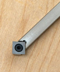Carbide woodturning tool with square cutter at tip and brushed aluminum shaft.