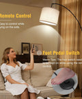 Lit Tall Arc Floor Lamp With Remote Control 81 Inch Tall Dimmable LED with drum beige shade over beige sofa.