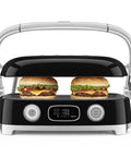 SMEG MGF01 Retro Countertop Electric Grill and Panini Press With Swappable Plates For Waffles, Burgers, And Steak grilling two burgers with cheese and lettuce.
