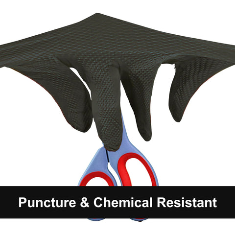 Black nitrile disposable glove with diamond-texture grip worn on hand holding blue scissors