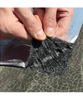 Close-up of hands peeling Built Tough 2mm Thick Butyl Roof Repair Tape Self Adhesive Aluminum Foil for sealing.