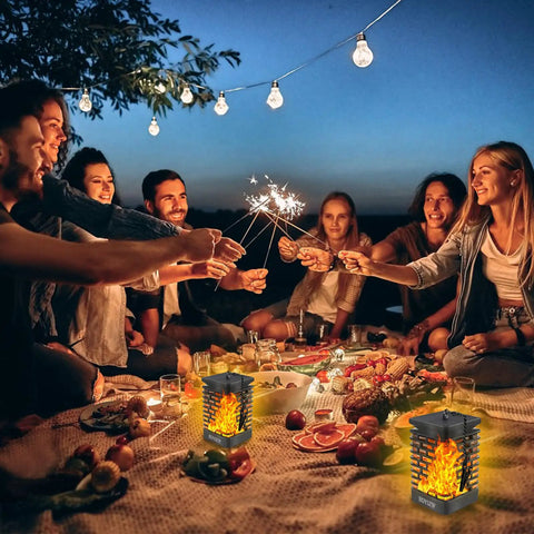 Group gathered around picnic table with Two Pack Solar Lanterns With Realistic Dancing Flame 99 LED Outdoor Lights for warm ambience