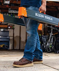 Tough As Nails Folding Sawhorses Heavy Metal Work Platform Non Skid Top Holds A Massive 1300 Lbs Each Rock Solid Rig For Carpenters And Contractors 2 Pack being carried in a garage.