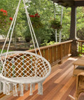 LED Macrame Hammock Chair For Indoor And Outdoor Use, Handmade Cotton Rope Swing With 12m LED String Lights, Large 55x75 Cm Comfort Seat on a patio.
