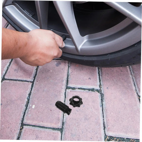 Durable Plastic Spare Tire Hold Down Bolt For Secure Mounting, Easy Installation, shown near wheel for reliable use