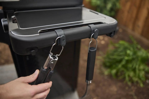 Hand attaching tongs to 3 Pack Rail Mounted Grill Tool Hooks For Hanging Spatulas Tongs Brushes And Other BBQ Gear On Side Rails