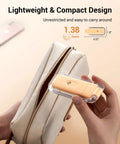 Person holding USB Rechargeable Clip On Reading Light with amber and warm white modes in compact size next to a beige bag.